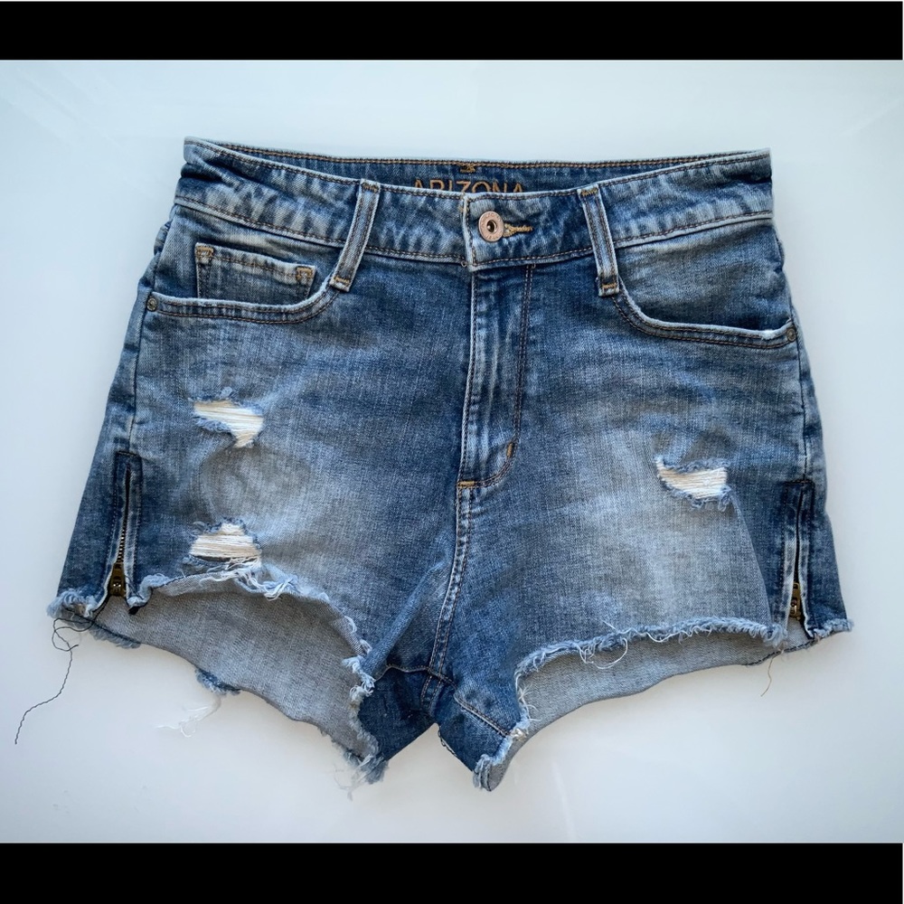 Regular blue jeans with a few mini rips and two small zippers on each side